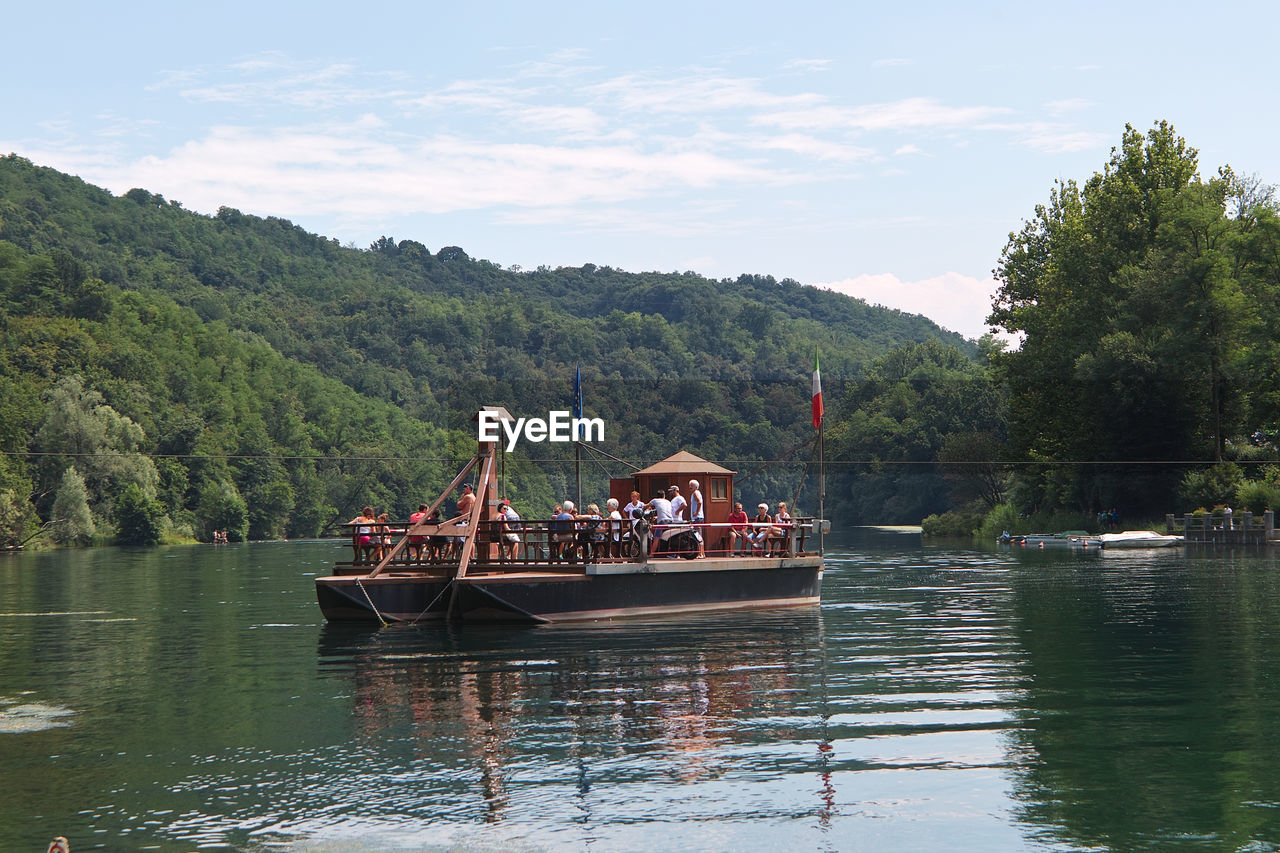 BOAT IN LAKE AGAINST SKY