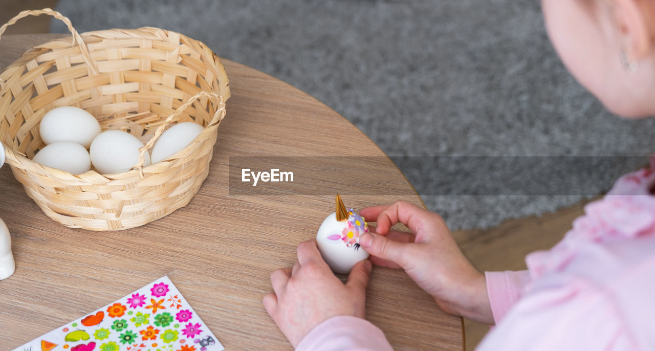 cropped hand of person holding food on table