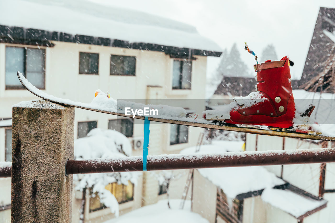 Snow-covered red ski boat on a rail