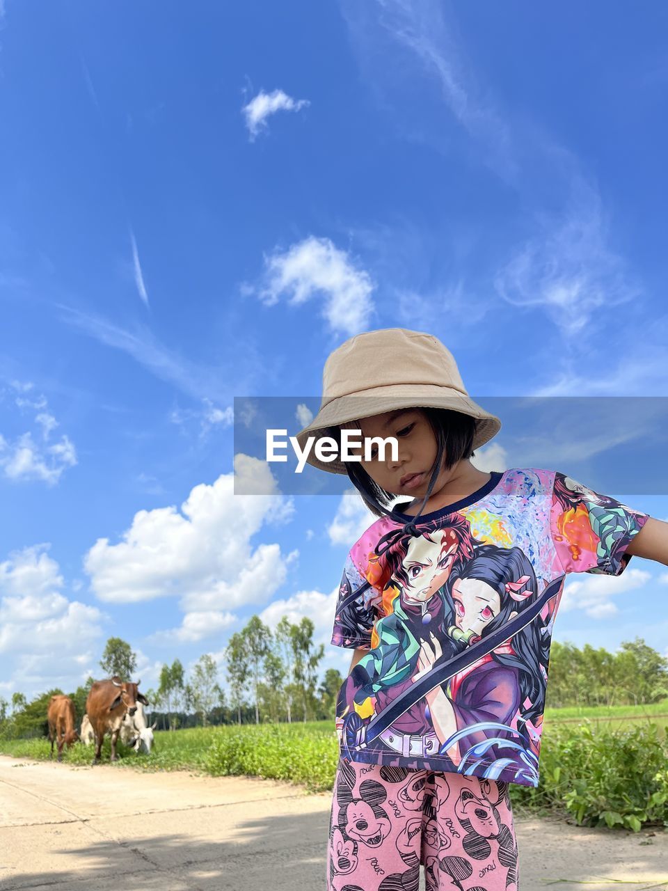 Low angle view of woman holding umbrella 