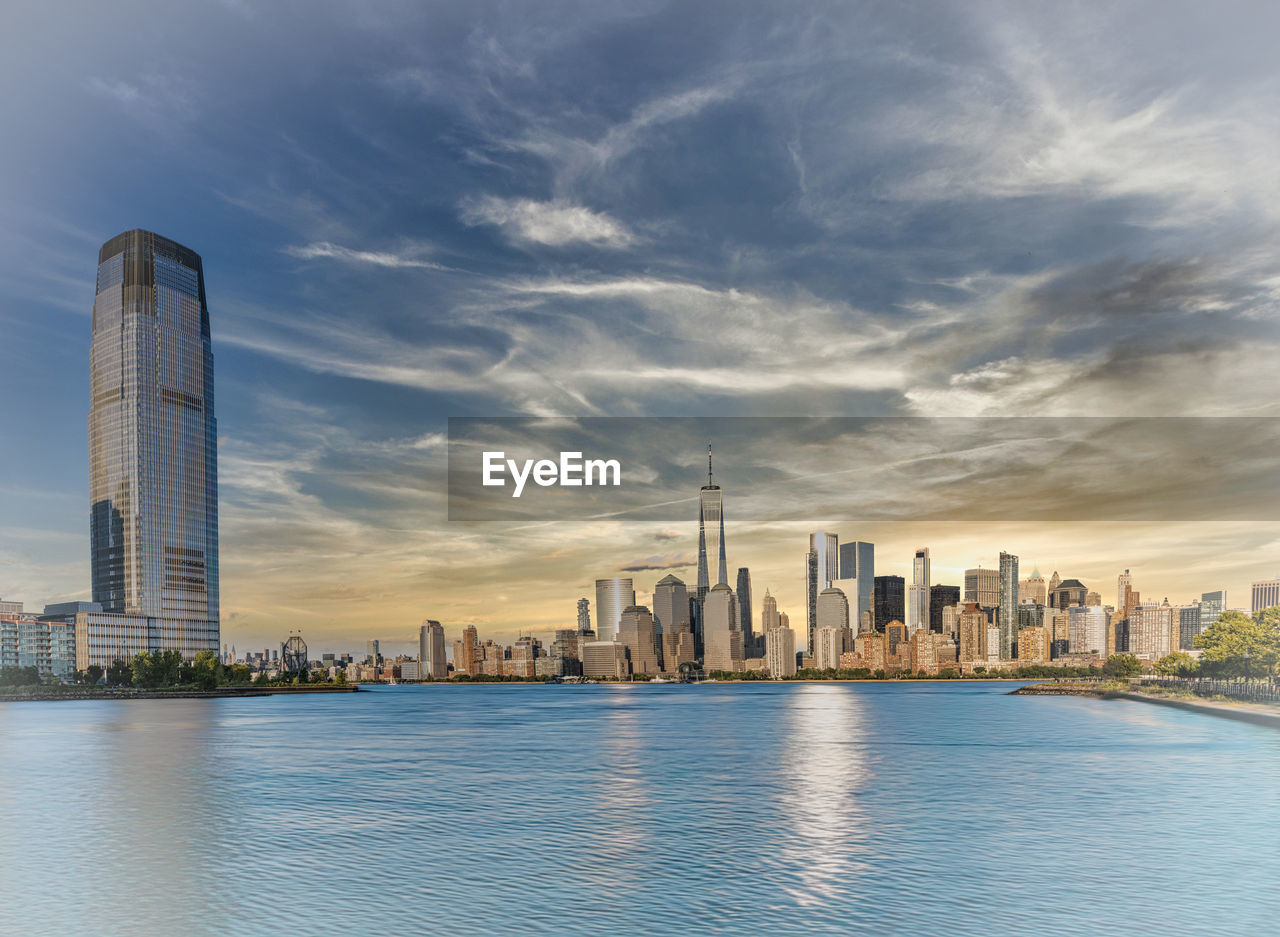 architecture, city, built structure, building exterior, building, office building exterior, landscape, skyline, skyscraper, urban skyline, sky, horizon, cityscape, water, travel destinations, downtown district, nature, residential district, cloud, office, downtown, landmark, reflection, tower block, urban area, city life, travel, business, no people, waterfront, sunset, outdoors, tower, dusk, river, business finance and industry, metropolis, financial district, tourism, metropolitan area, blue, daytime, scenics - nature, environment, development