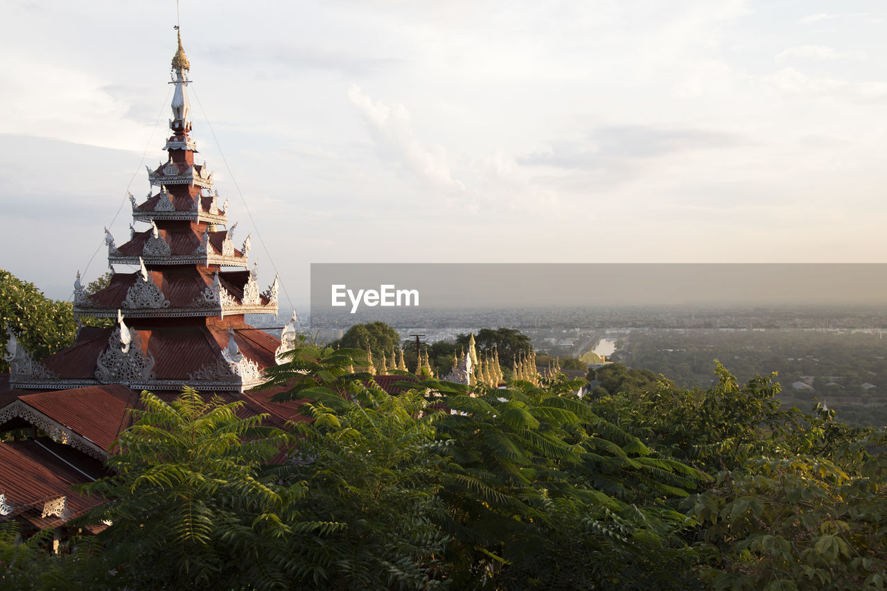 Red pagoda with mandalay's cityscape viewed from mandalay hill