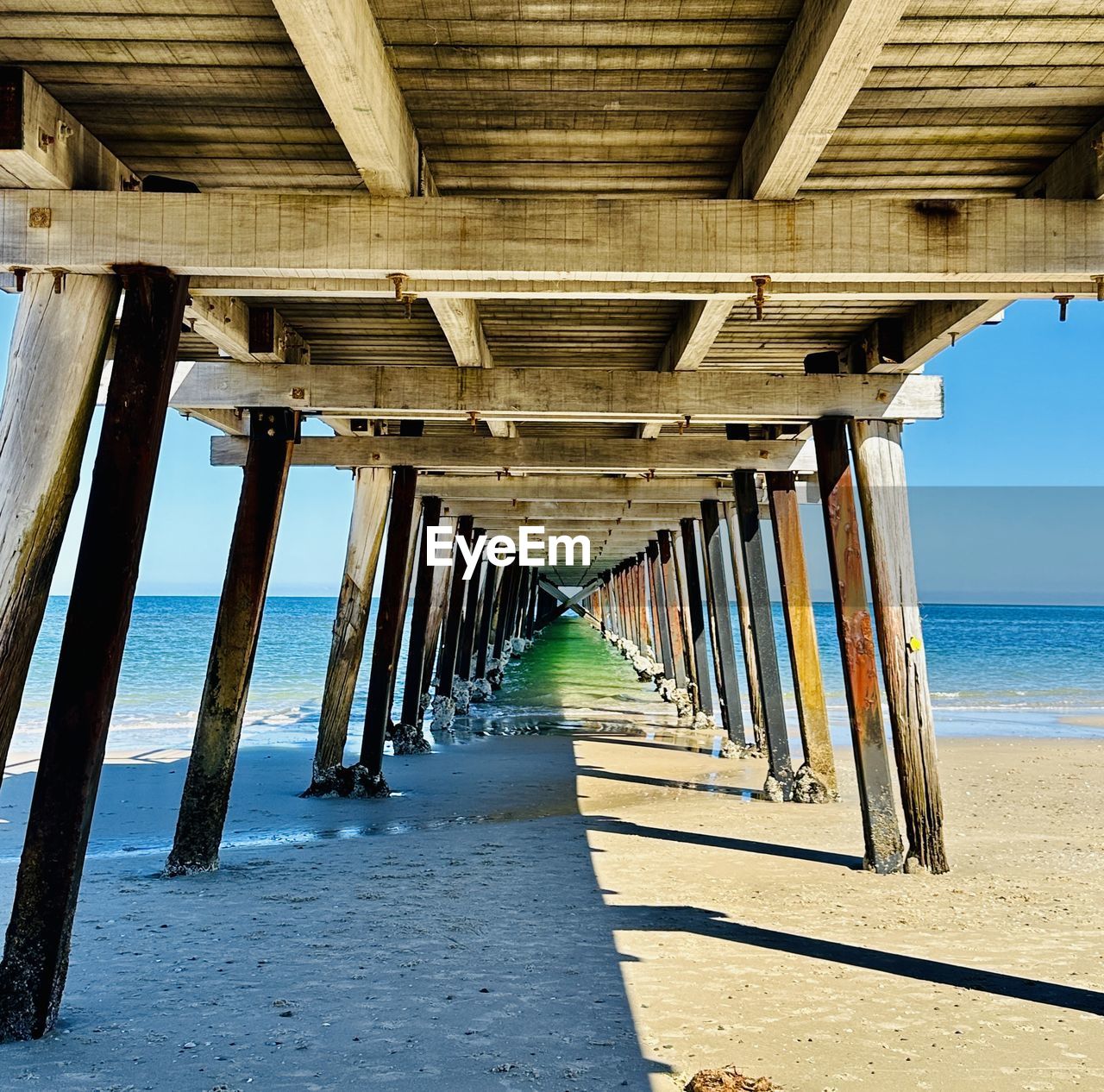 water, beach, sea, land, architecture, horizon over water, nature, built structure, sand, pier, architectural column, walkway, underneath, sky, horizon, wood, day, no people, bridge, outdoors, scenics - nature, diminishing perspective, beauty in nature, vacation, below, tranquility, transportation, the way forward, tranquil scene, in a row, sunlight