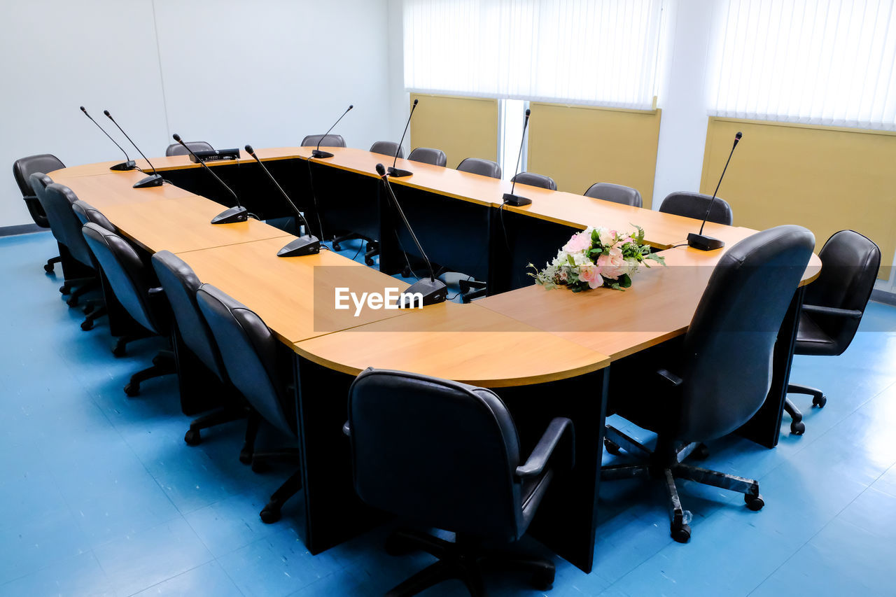 VIEW OF EMPTY CHAIRS AND TABLES IN BACKGROUND