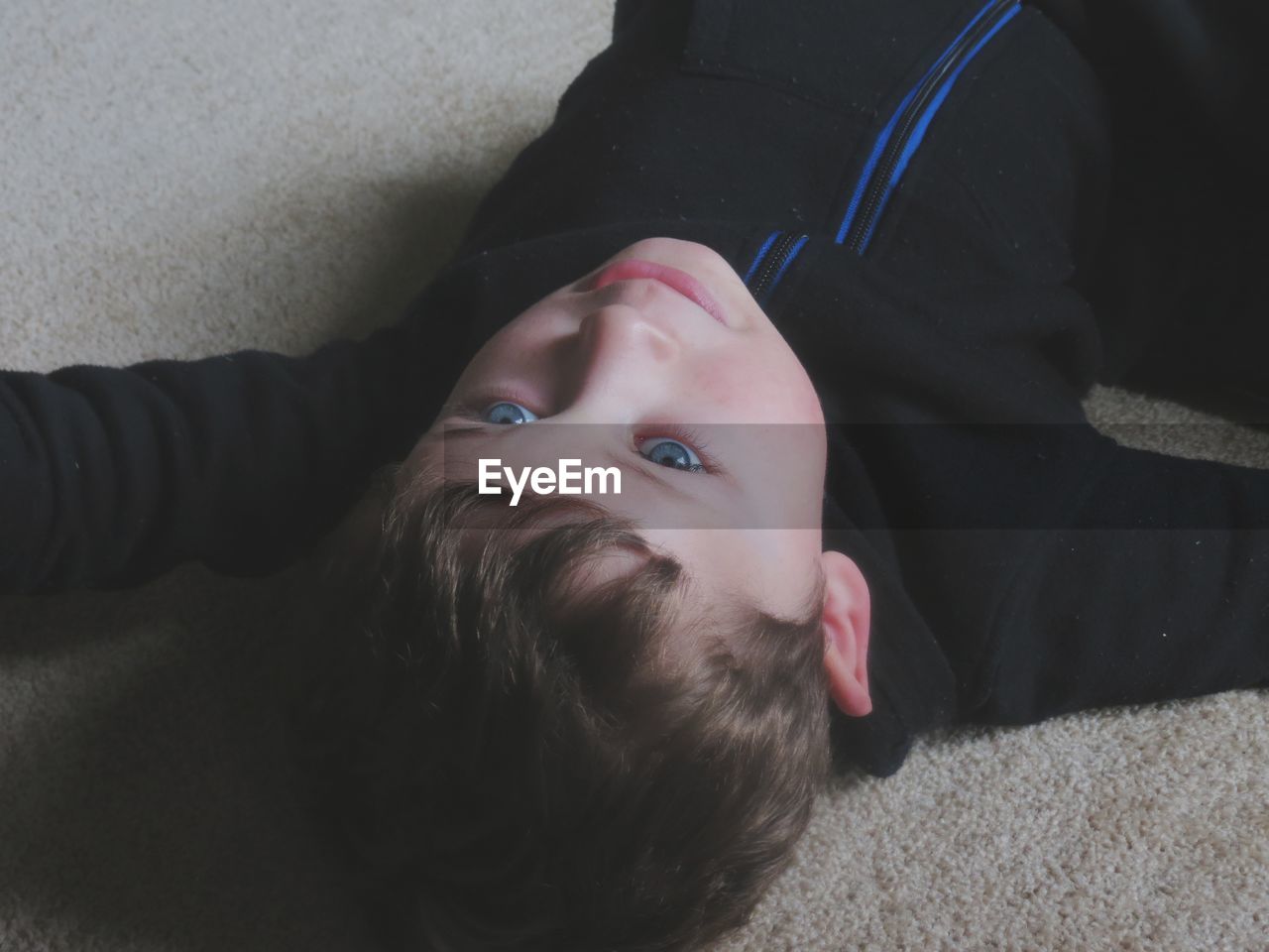 Cute boy lying on sofa at home