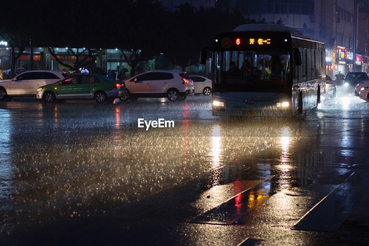 CARS ON WET STREET DURING RAINY SEASON