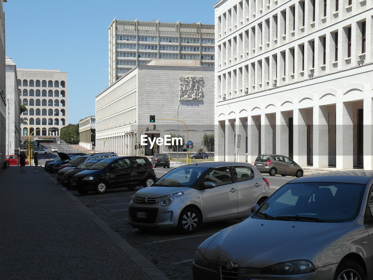 CARS ON STREET BY BUILDINGS IN CITY