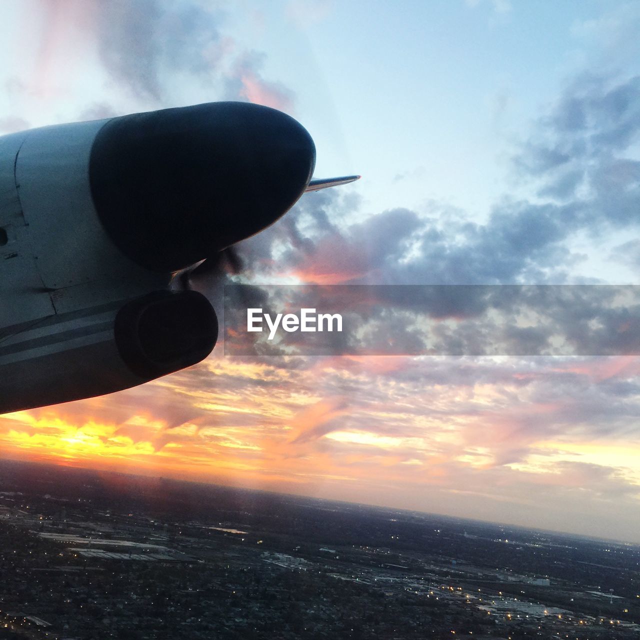 Ariel view of landscape against cloudy sky during sunset