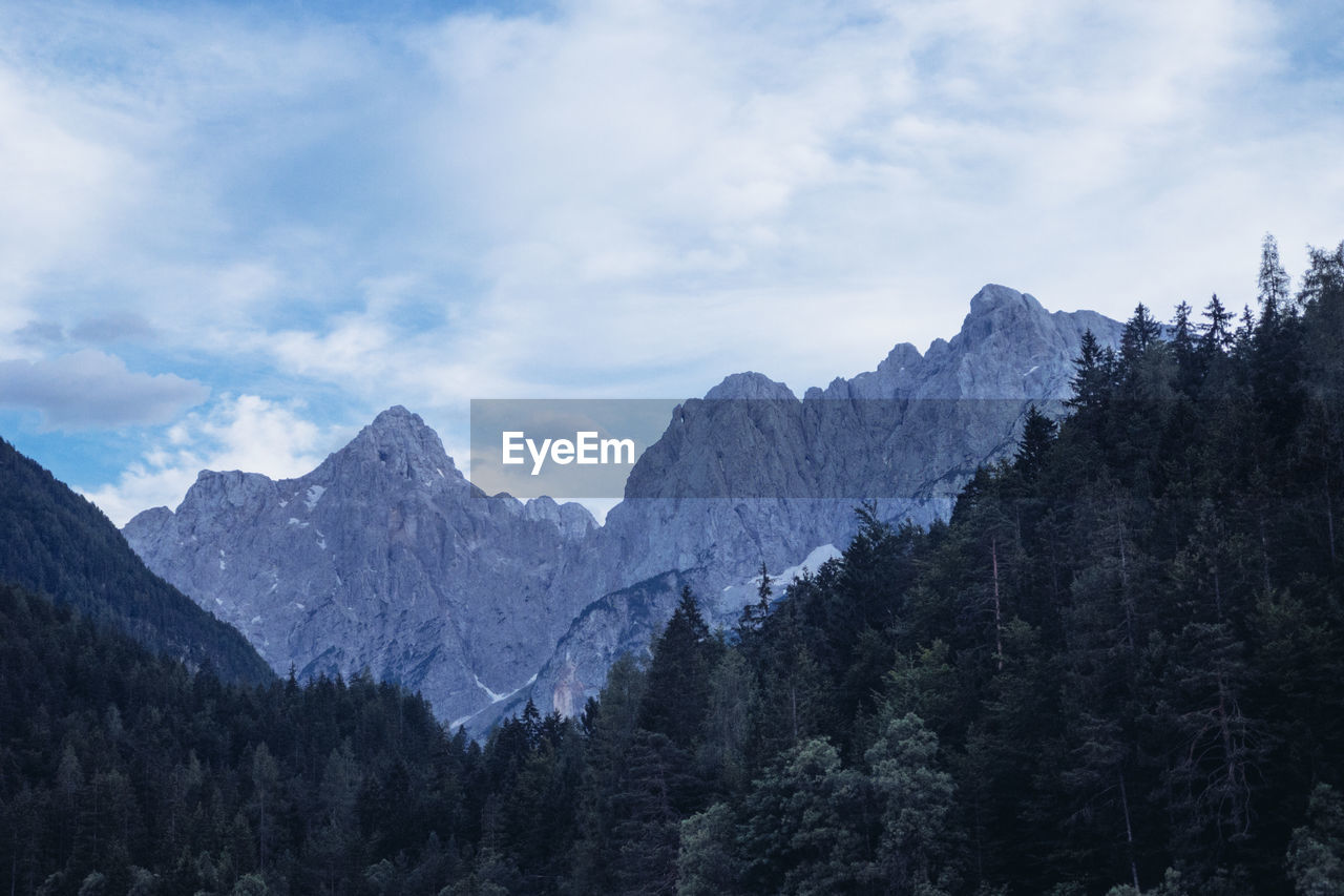 Scenic view of mountains against cloudy sky