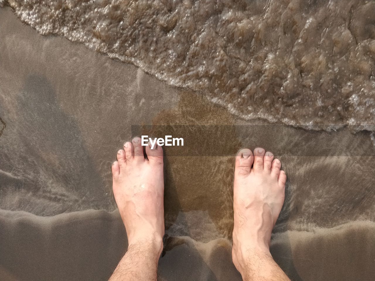 LOW SECTION OF MAN ON BEACH