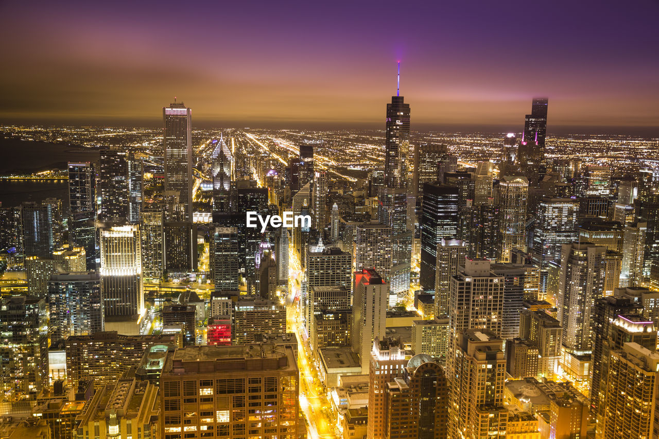 High angle view of city lit up at night