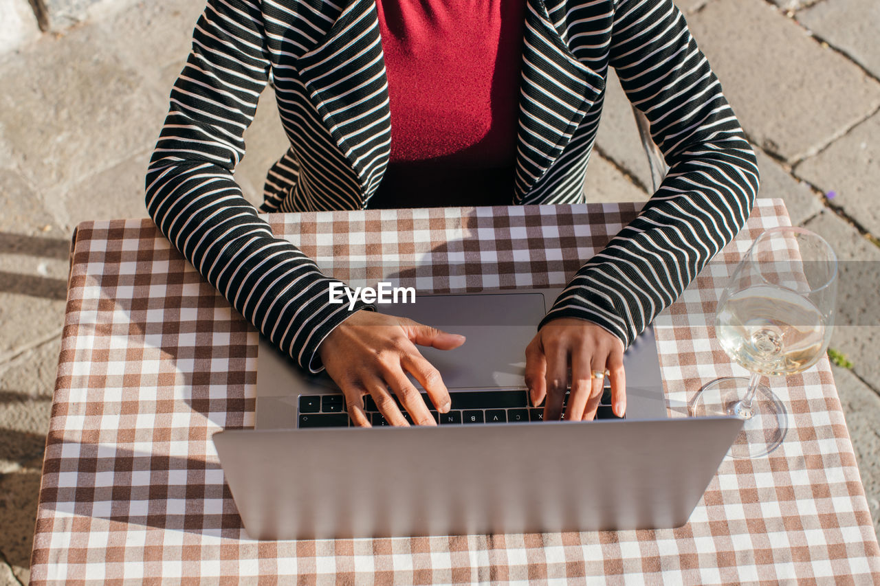Young businesswoman typing on laptop computer, close up