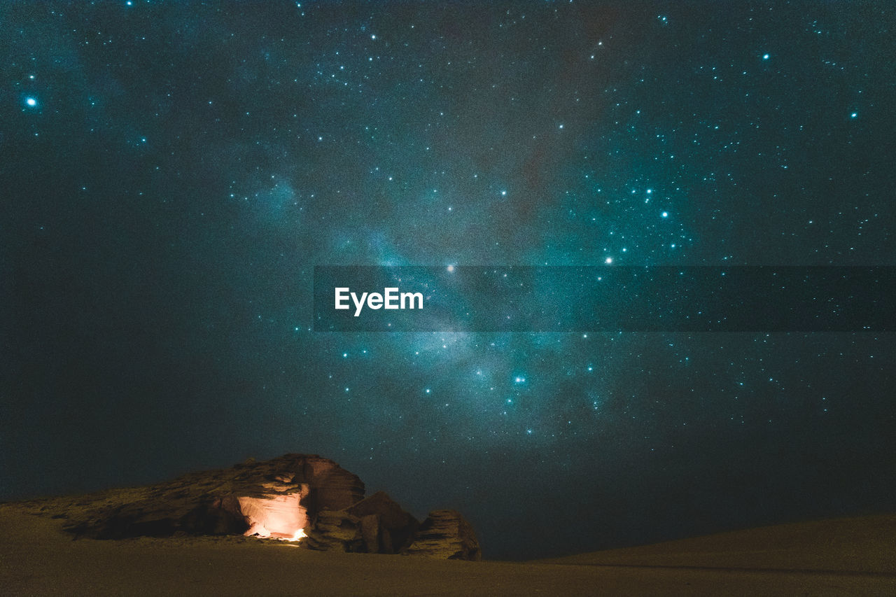 Scenic view of landscape against star field