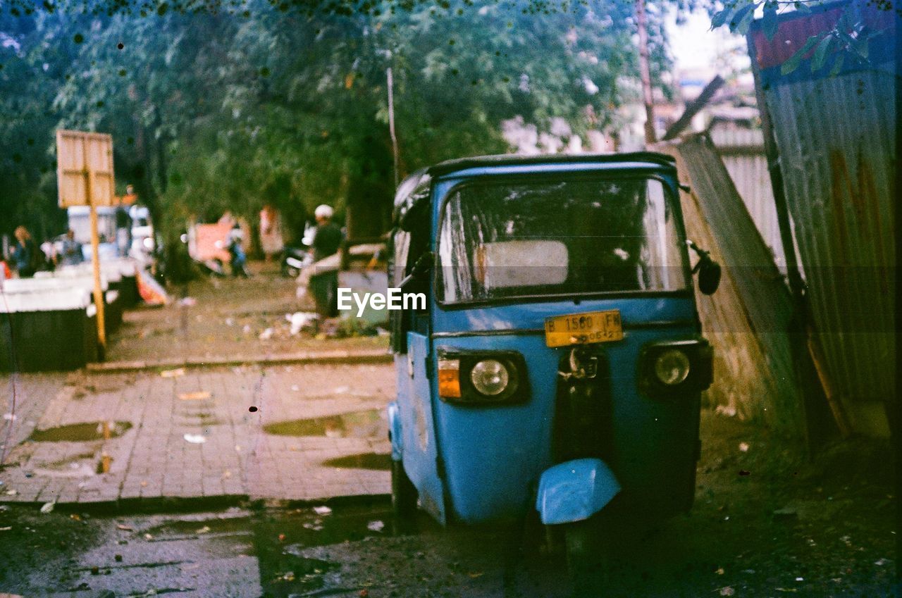 Abandoned car on road in city