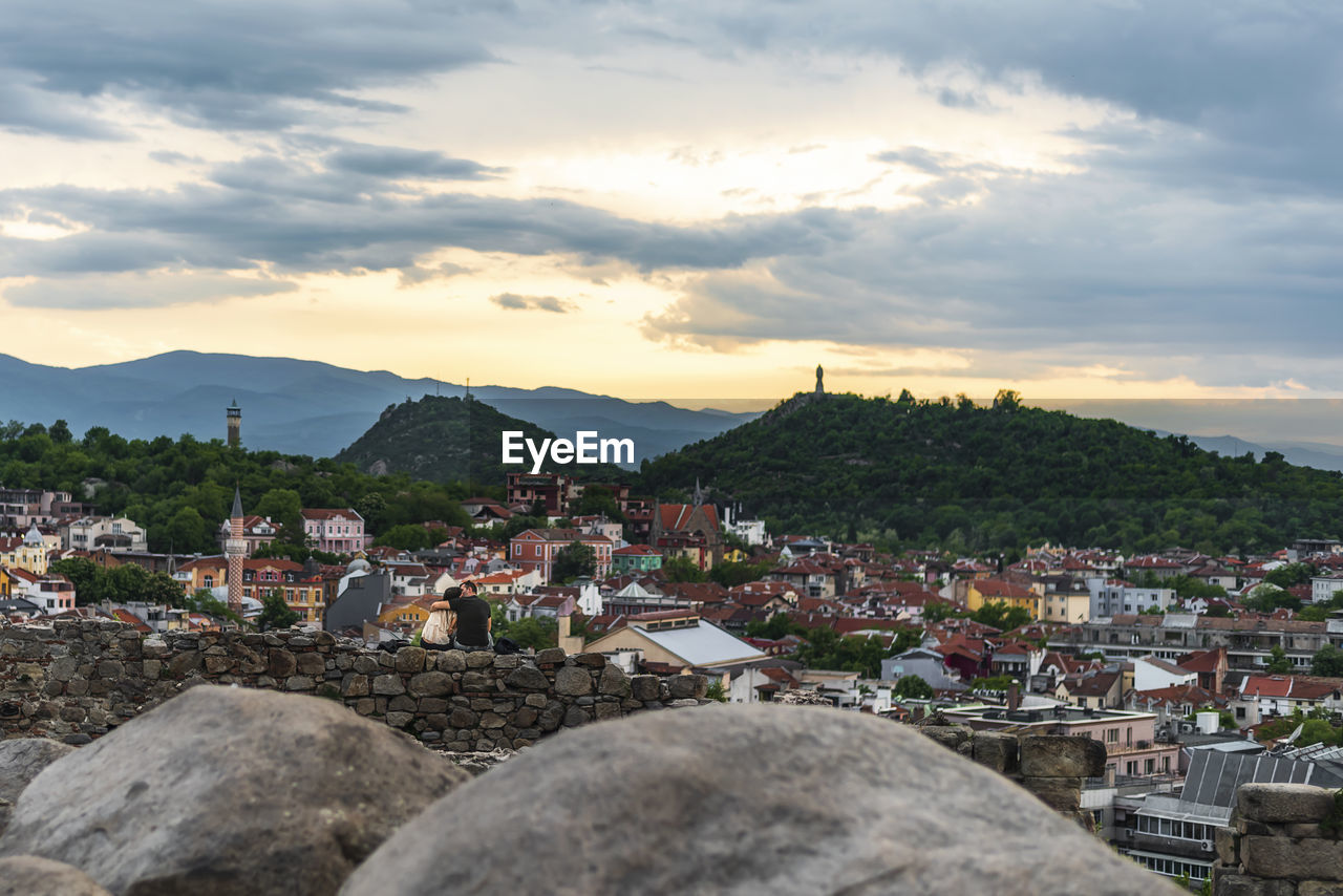 TOWNSCAPE AGAINST SKY AT SUNSET