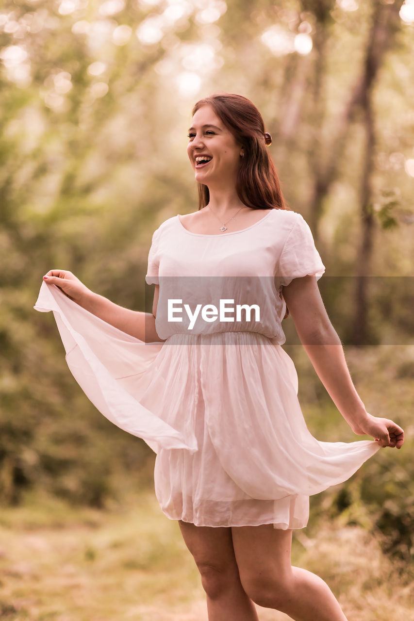 Happy woman standing on field