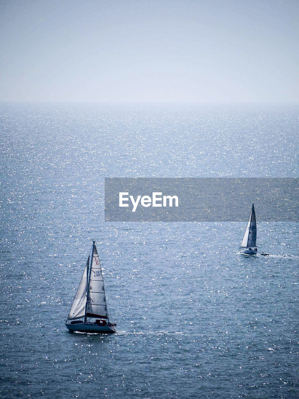 High angle view of sailboats in sea against sky