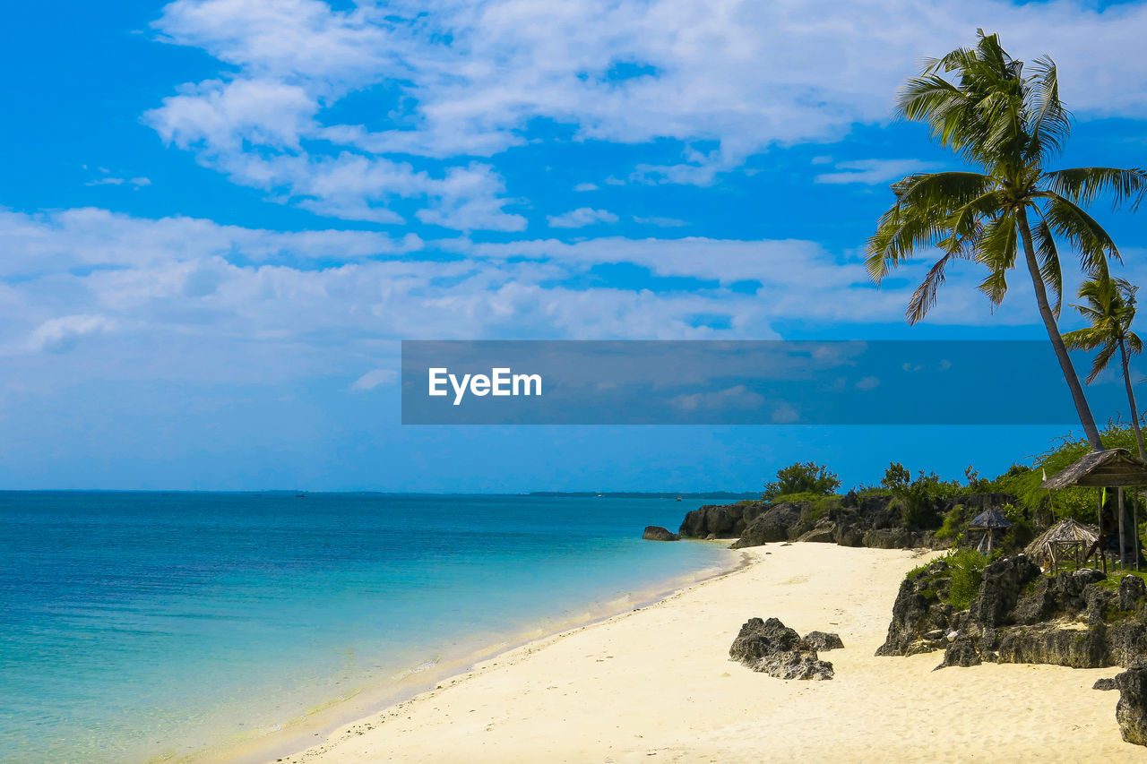 Scenic view of beach against blue sky