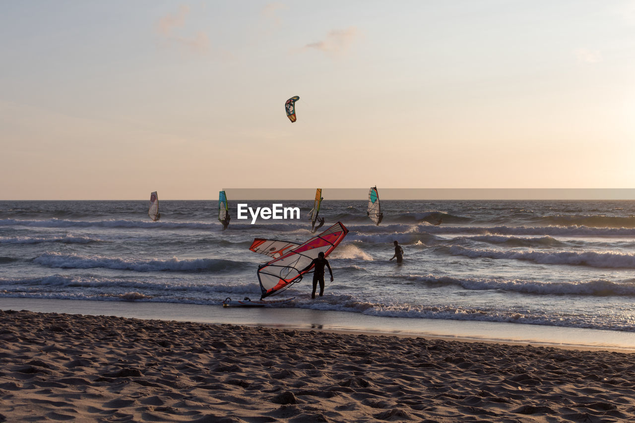 Scenic view of beach against sky during sunset