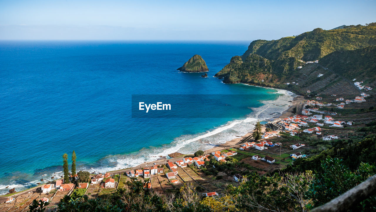 high angle view of sea and mountains against sky