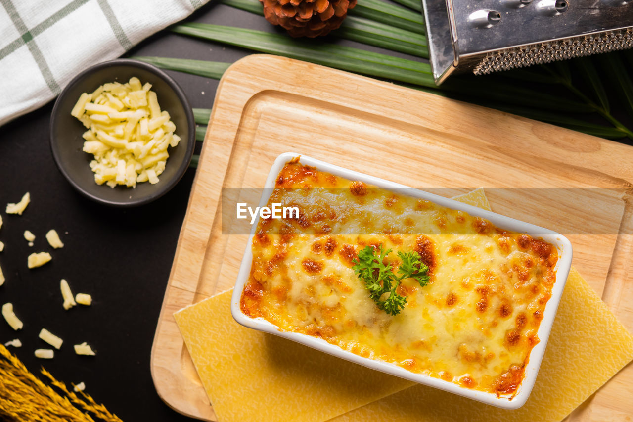 Directly above shot of lasagne in container on cutting board