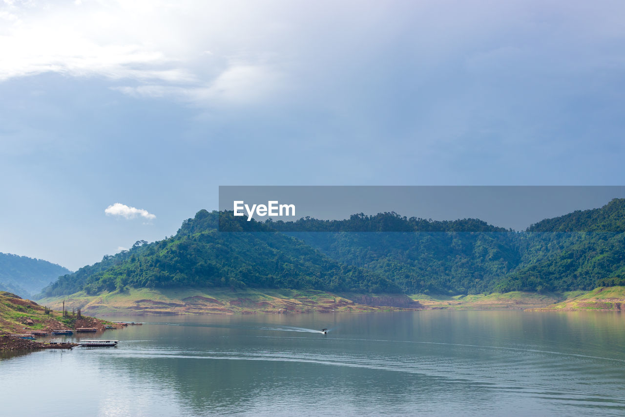 SCENIC VIEW OF LAKE BY TREES AGAINST SKY