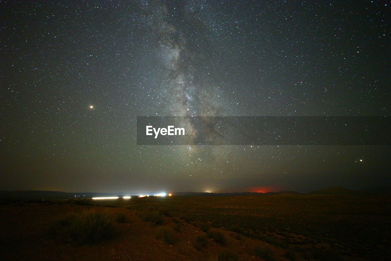 Scenic view of landscape against sky at night