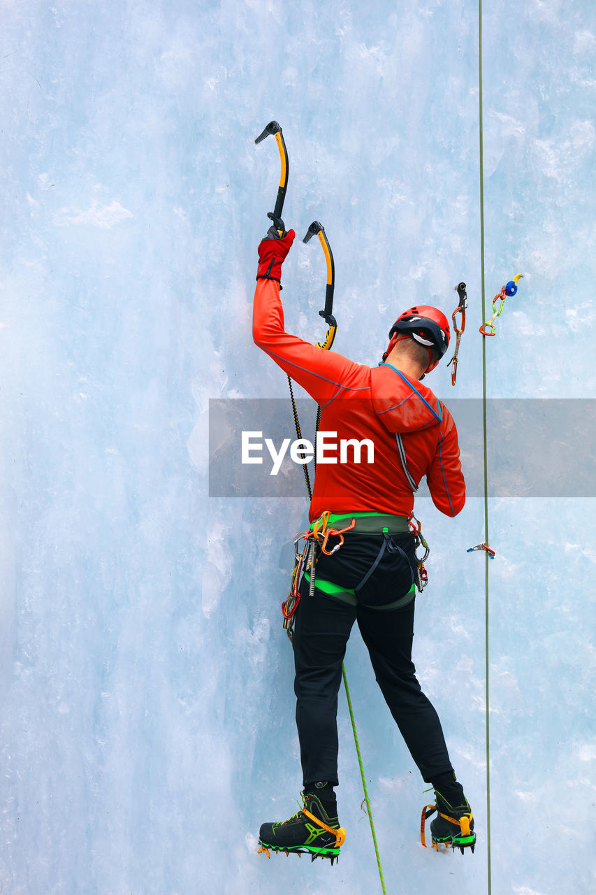 Full length of man climbing glacier