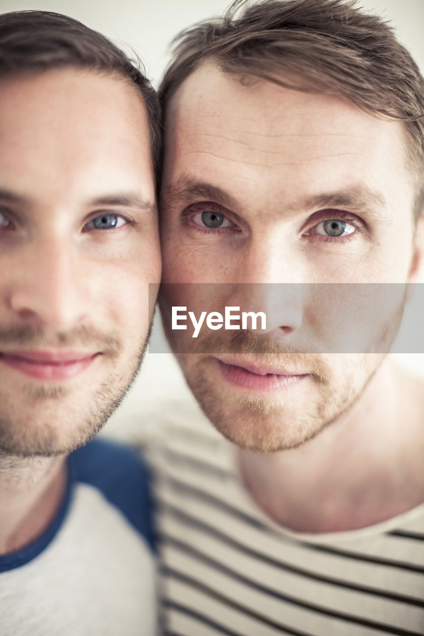 Close-up portrait of homosexual couple cheek to cheek