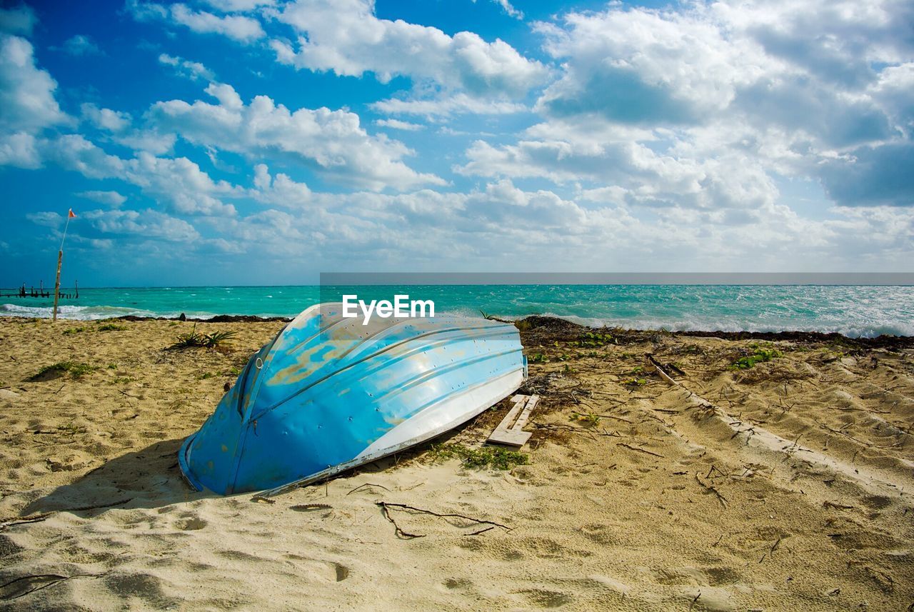 Boat on beach against sky