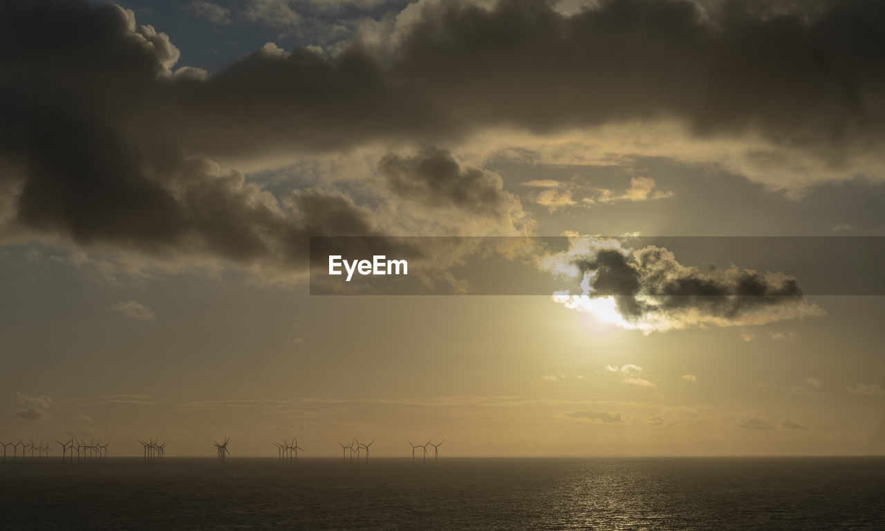 sky, cloud, horizon, beauty in nature, water, sea, scenics - nature, nature, sunlight, tranquility, sunset, environment, horizon over water, tranquil scene, dusk, ocean, sun, dramatic sky, outdoors, no people, idyllic, afterglow, evening, silhouette, cloudscape, seascape