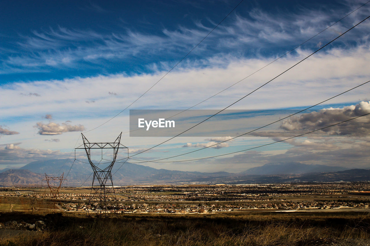 ELECTRICITY PYLONS ON LAND AGAINST SKY