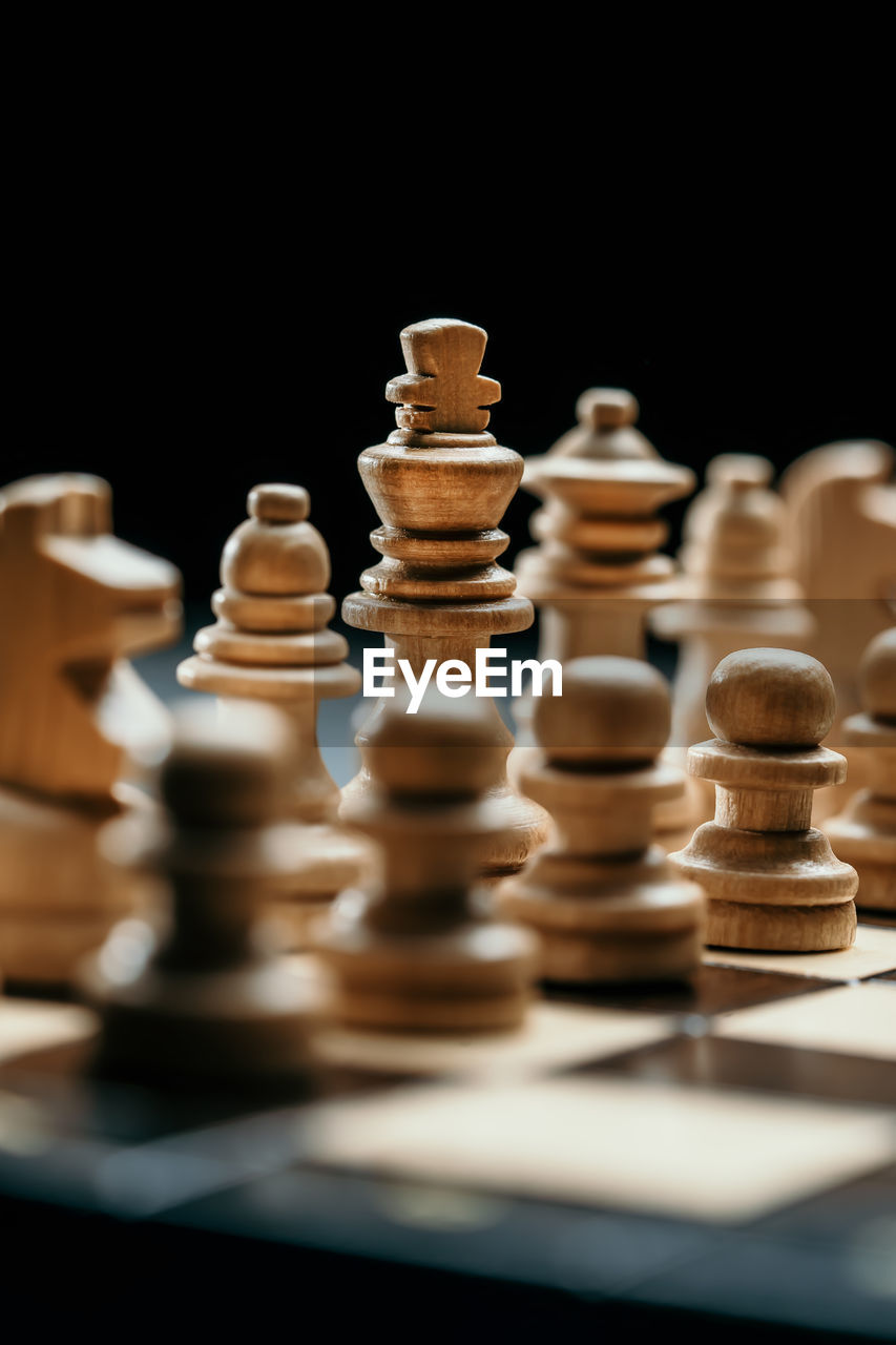 Close-up of chess pieces against black background