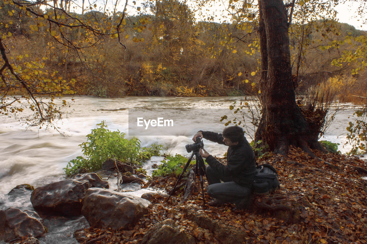 Man photographing river