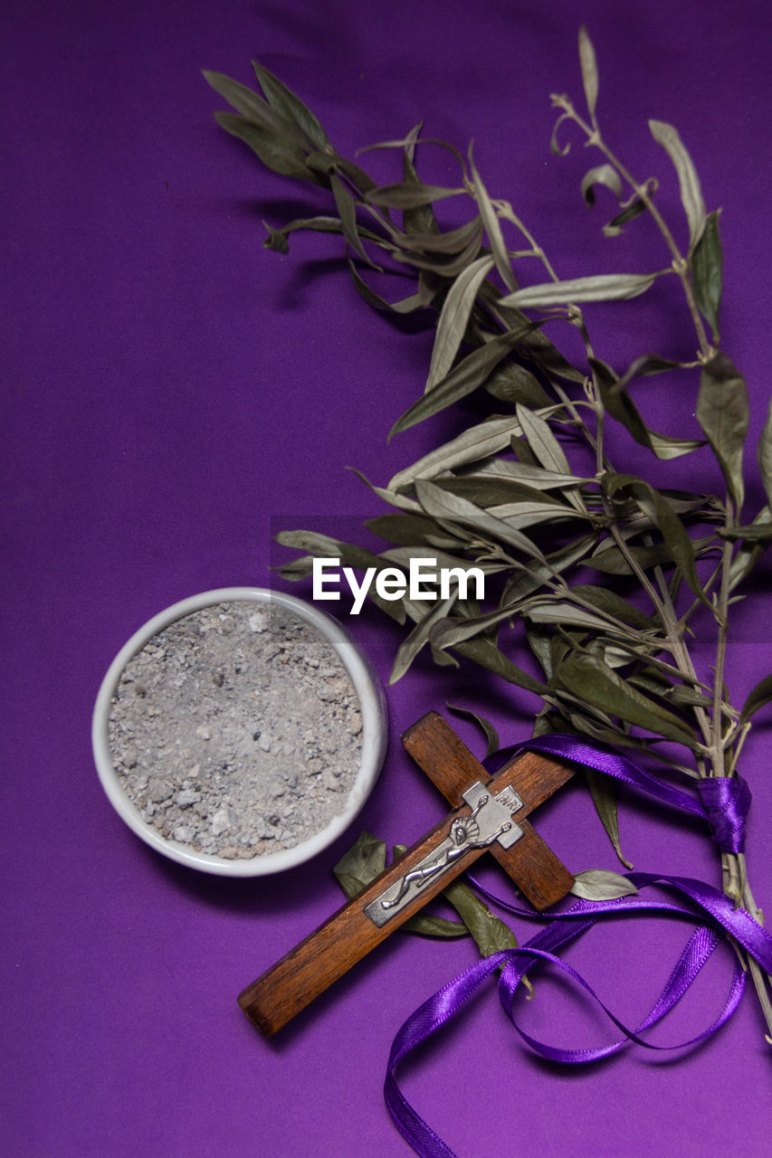 Bowl with ashes, olive branch and cross, symbols of ash wednesday