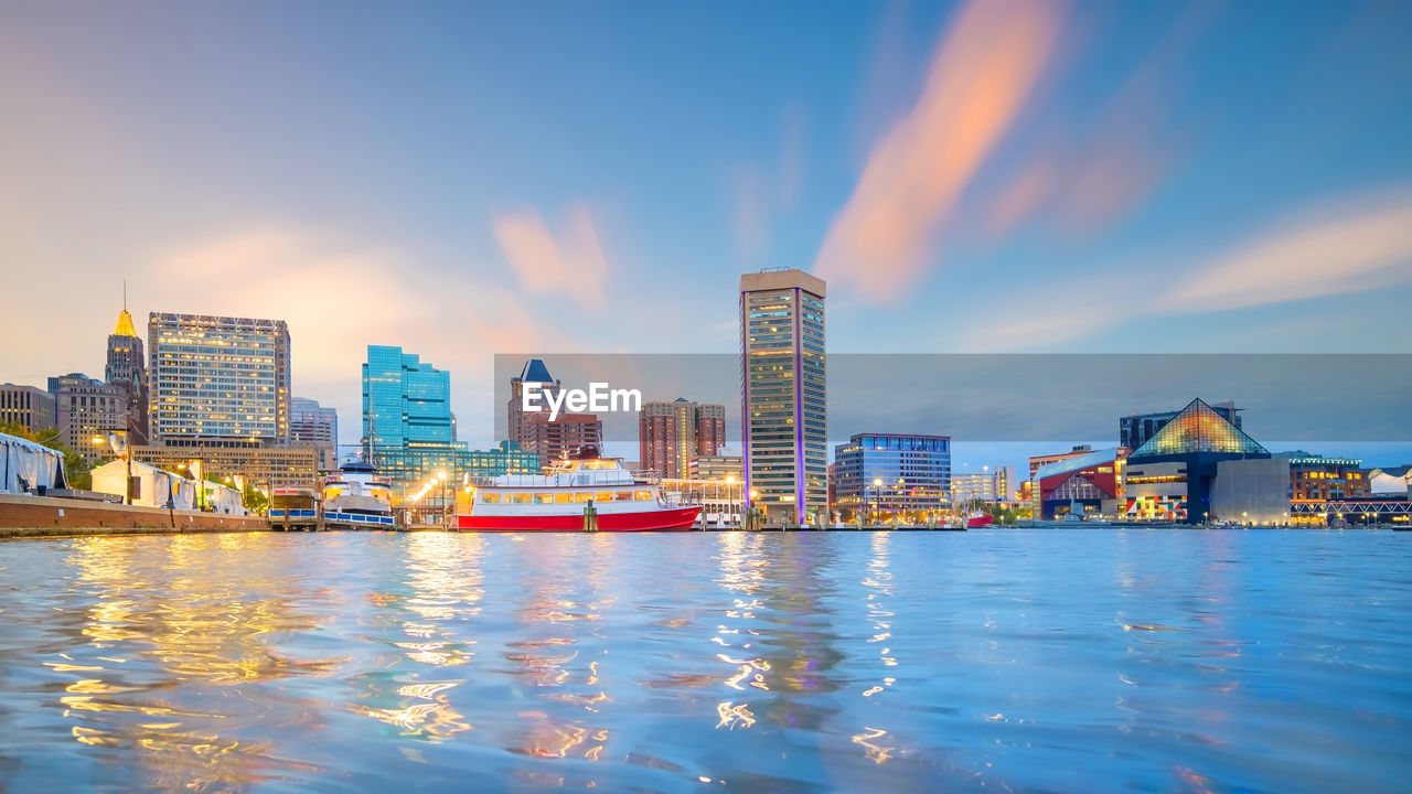 RIVER BY BUILDINGS AGAINST SKY