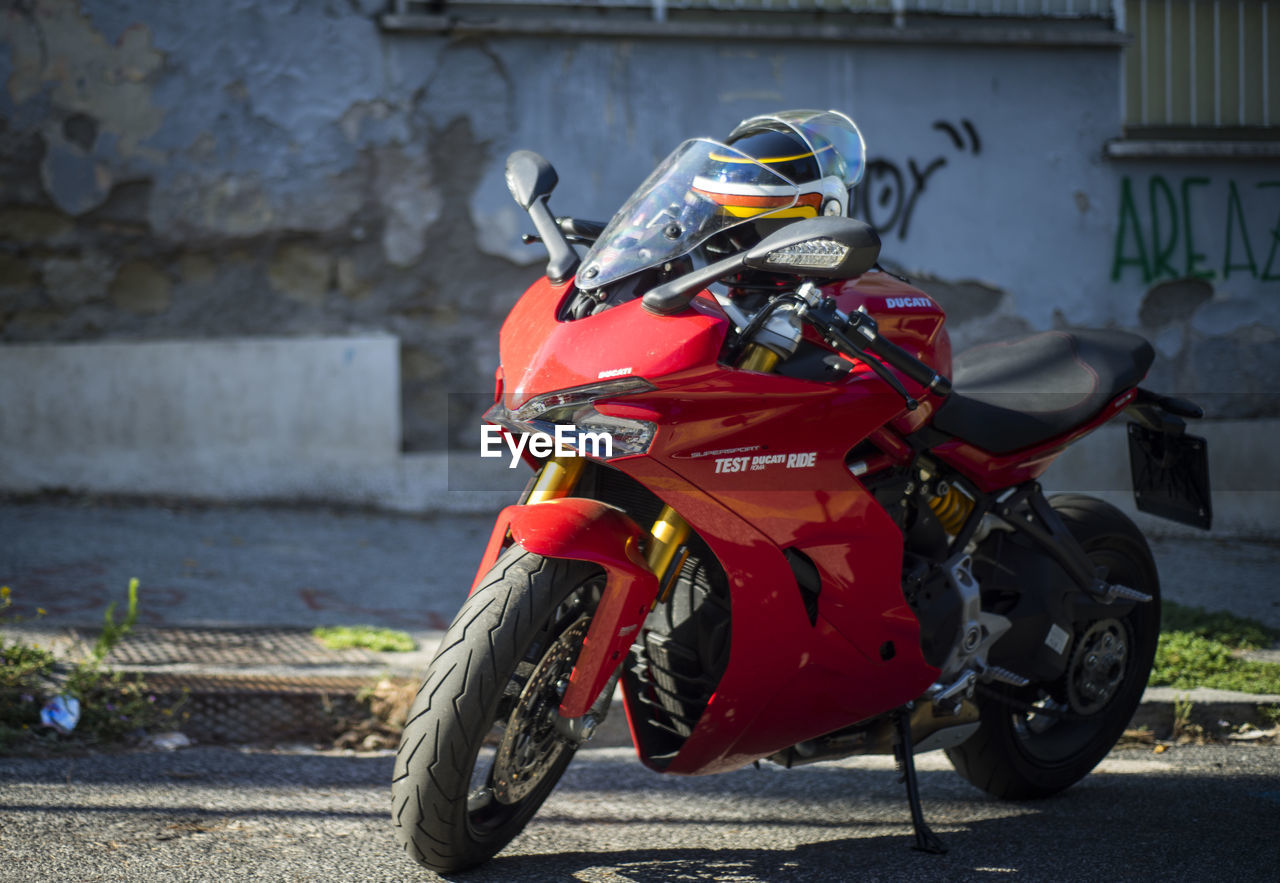 Motorcycle ducati parked on street in city