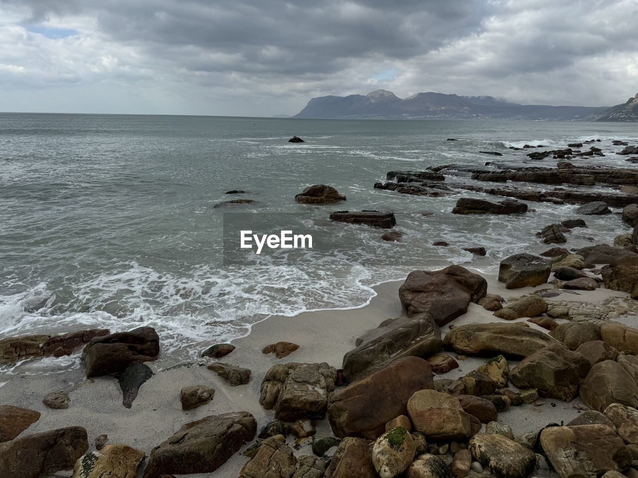 sea, water, land, beach, sky, rock, cloud, body of water, shore, coast, beauty in nature, scenics - nature, wave, ocean, nature, environment, wind wave, coastline, landscape, travel destinations, motion, horizon over water, travel, sand, dramatic sky, seascape, horizon, tranquility, bay, no people, overcast, outdoors, tourism, tranquil scene, water's edge, storm, holiday, cloudscape, trip, sports, terrain, day, vacation, cove, cliff, idyllic, storm cloud