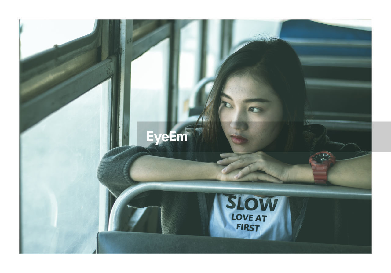 Young woman sitting in bus