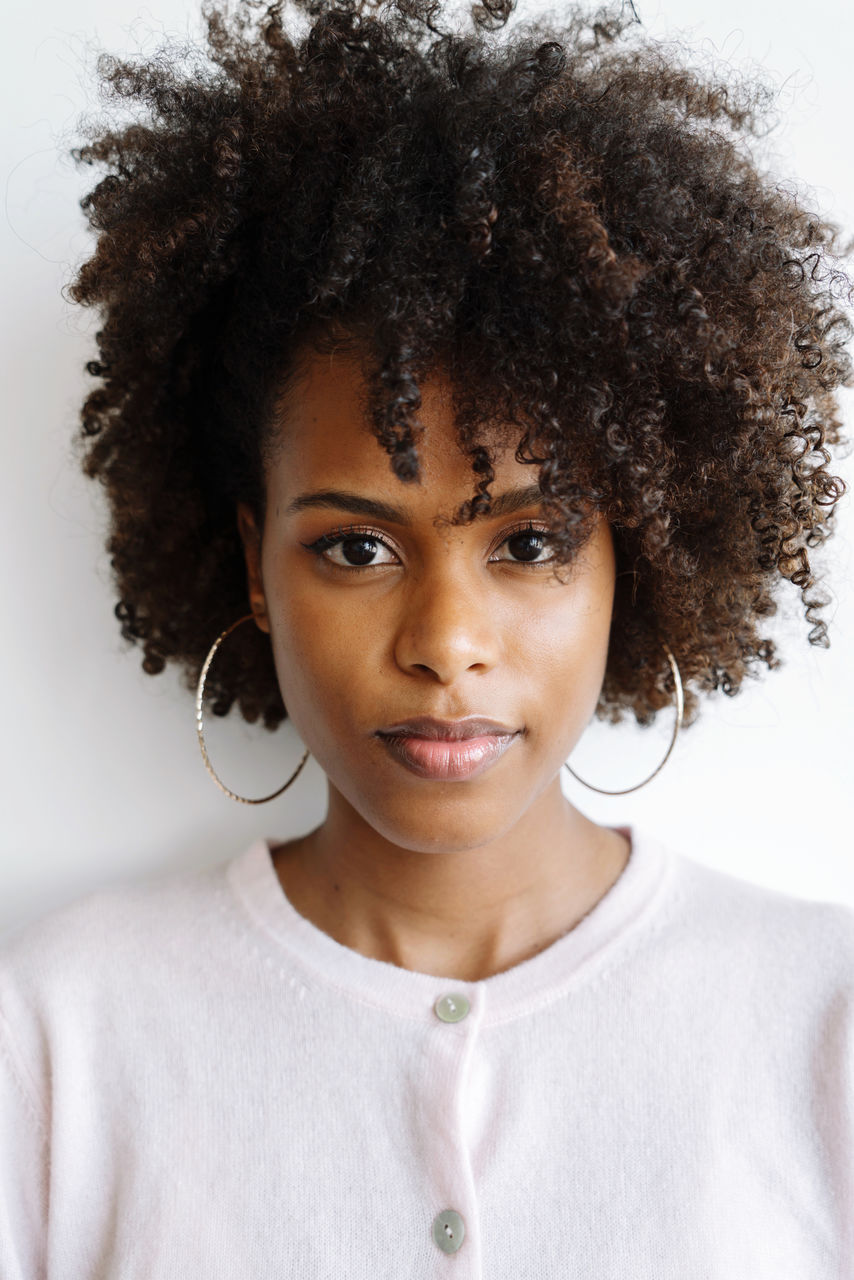 Portrait of a beautiful black woman with afro on the white background