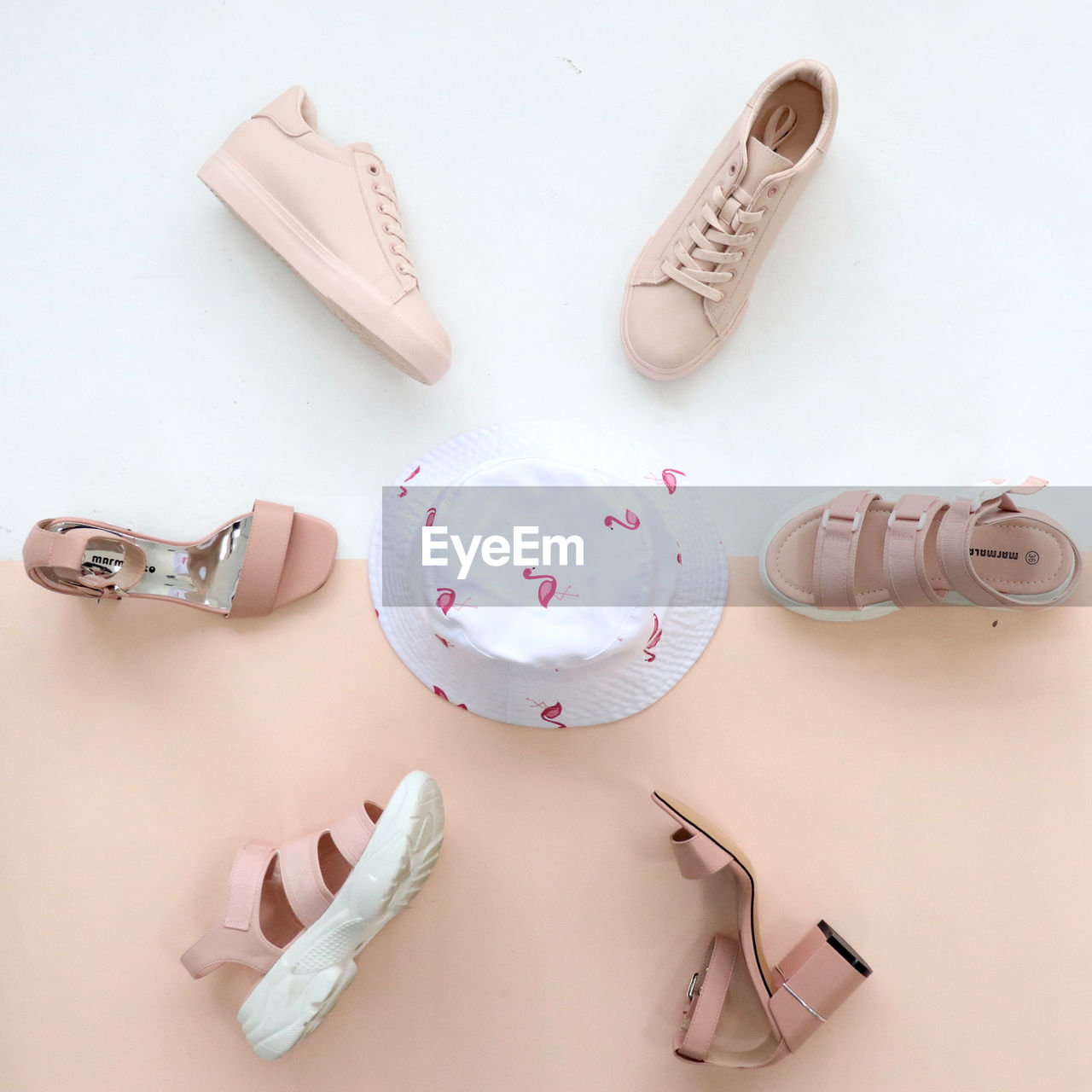 HIGH ANGLE VIEW OF WOMAN AND PINK SHOES ON WHITE TABLE