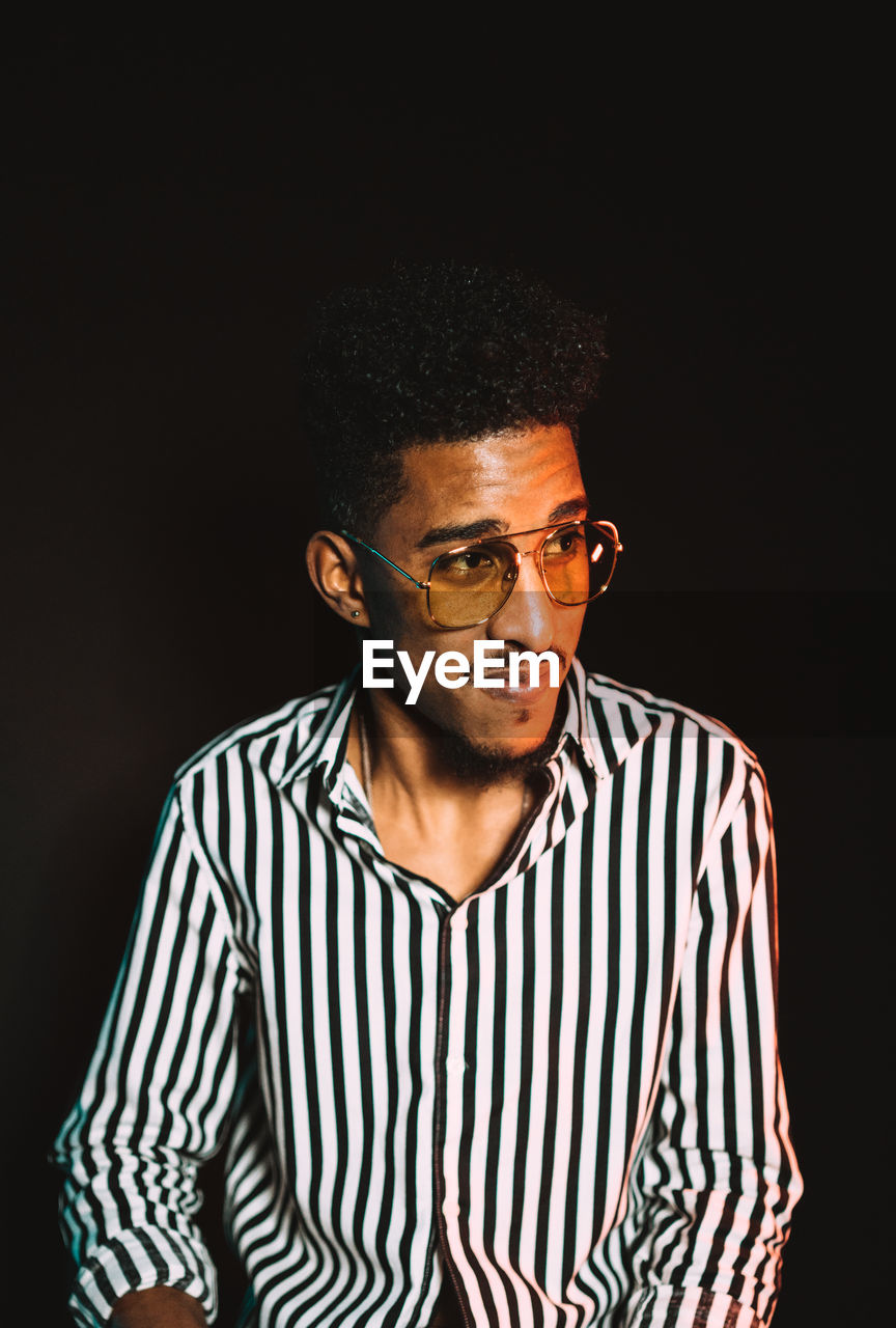 Portrait of young african american masculine male wearing stylish clothes and eyeglasses