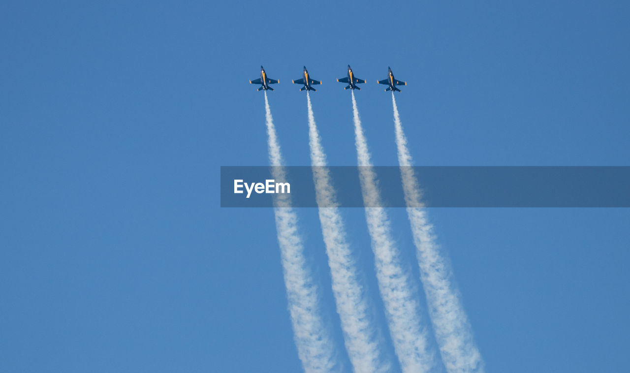 LOW ANGLE VIEW OF AIRSHOW AGAINST SKY