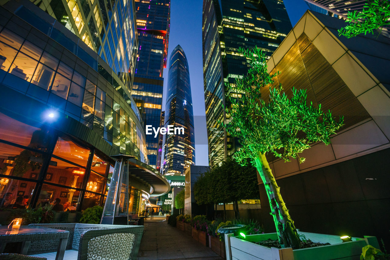 Low angle view of illuminated buildings in city at night