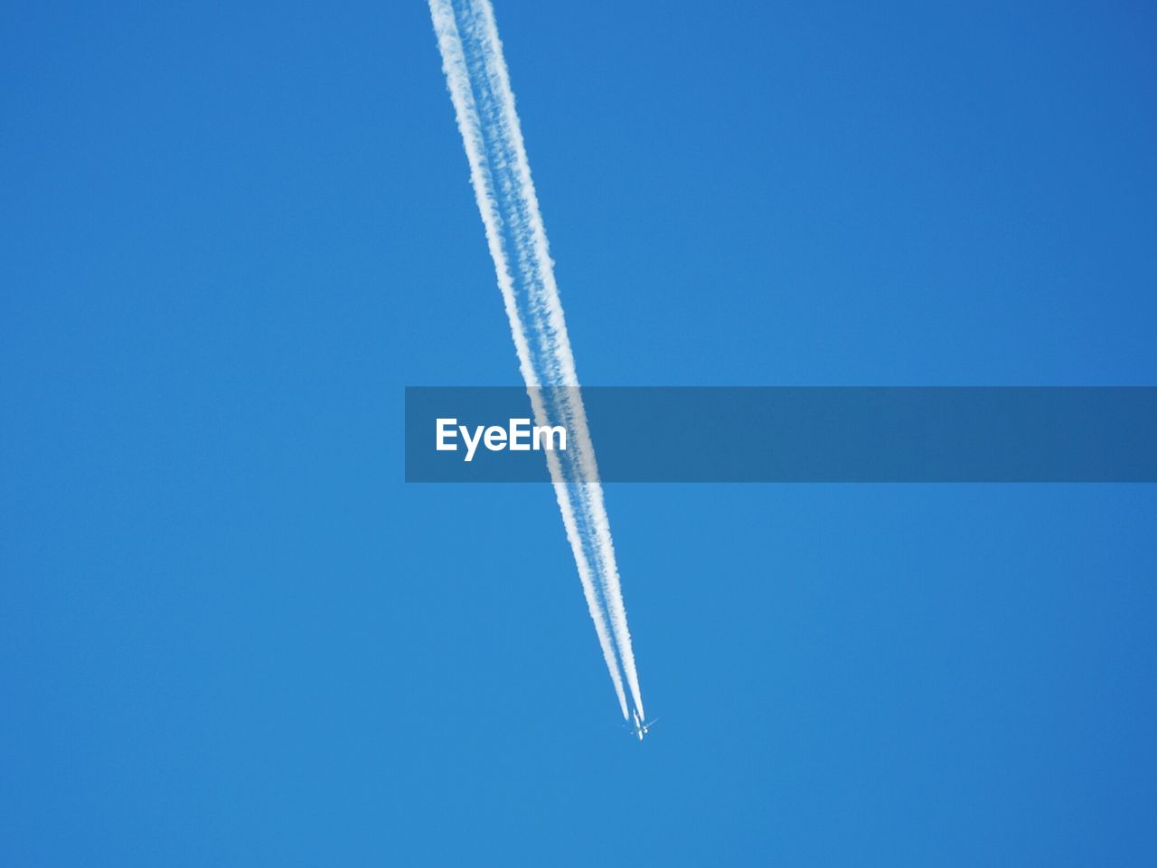 Airplane flying against clear blue sky