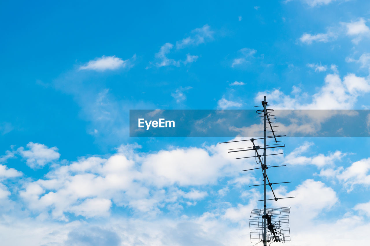 Low angle view of communications tower against sky