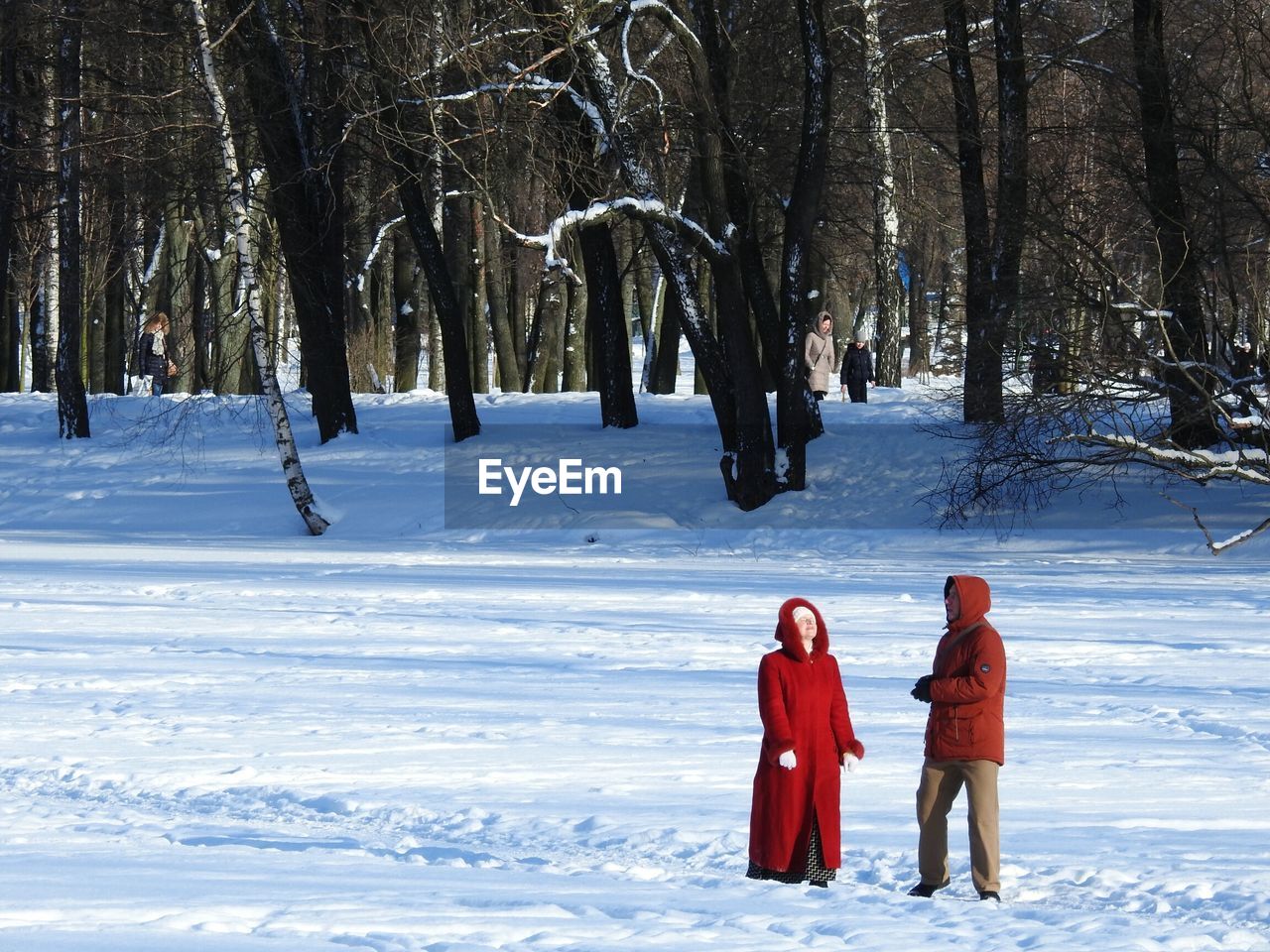 REAR VIEW OF TWO PEOPLE WALKING IN SNOW