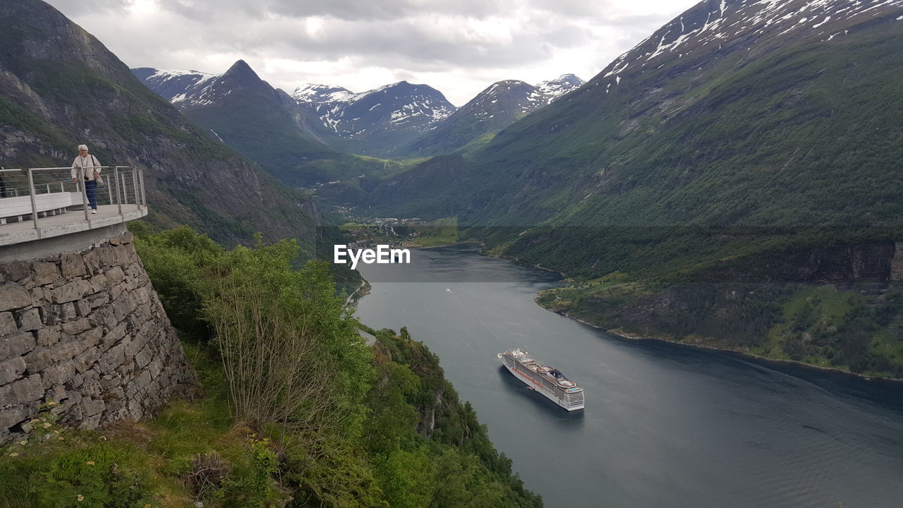 Scenic view of geirangerfjord amidst mountains