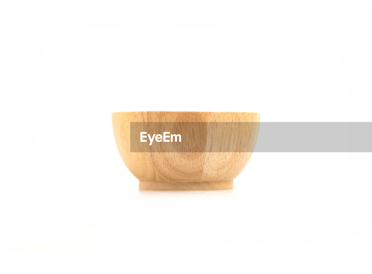 Close-up of wooden bowl against white background
