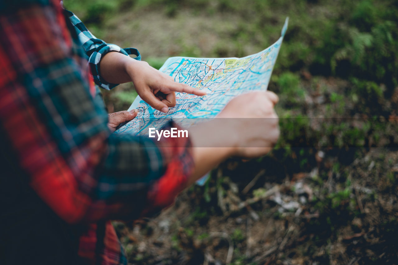 People discussing maps on land